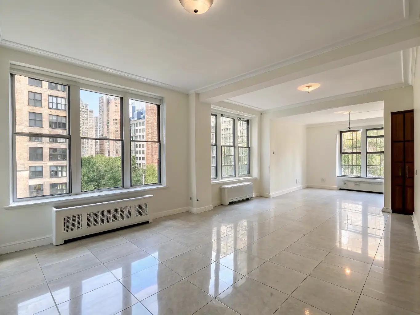 An empty apartment with freshly cleaned floors and windows, ready for new tenants. The space is bright and airy, reflecting the thoroughness of the move-in/move-out cleaning service.